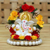 Handmade Lord Ganesha idol on a handcrafted rose flower plate, made of resin. Dimensions 10x8x8 cm, weighing 300g. Ideal for home decor and gifting.