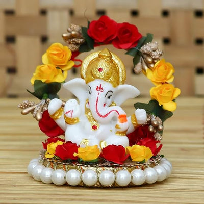 Handmade Lord Ganesha idol on a handcrafted rose flower plate, made of resin. Dimensions 10x8x8 cm, weighing 300g. Ideal for home decor and gifting.