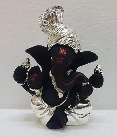 Handmade ceramic Ganesha idol for car dashboard, measuring 5.1cm x 3.6cm x 7.6cm, showcasing intricate details and vibrant colors.