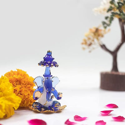 A beautifully crafted glass Ganesha idol, showcasing intricate details, ideal for home decor or car dashboards.