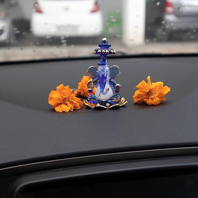 A beautifully crafted glass Ganesha idol, showcasing intricate details, ideal for home decor or car dashboards.