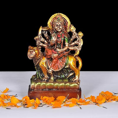 Handmade resin statue of Goddess Durga riding a lion, intricately designed, ideal for home or altar decor, symbolizing strength and divine power.
