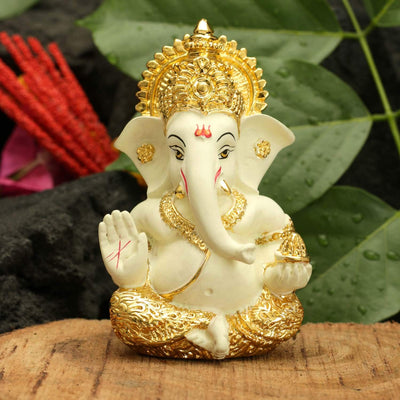 Handcrafted gold-plated Ganesha idol made of ceramic, symbolizing protection and good fortune, ideal for car interiors and altars.
