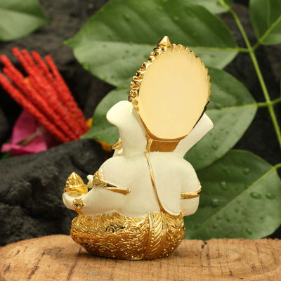 Handcrafted gold-plated Ganesha idol made of ceramic, symbolizing protection and good fortune, ideal for car interiors and altars.