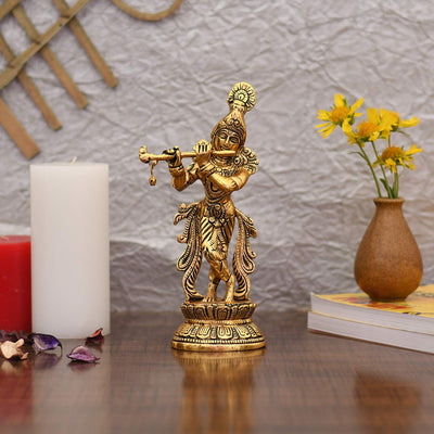 Handcrafted gold-plated Krishna statue playing the flute, featuring intricate details and vibrant colors, ideal for home decor or altar.