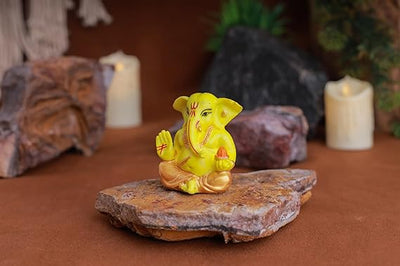 Gold-plated Lord Ganesha idol made of resin, symbolizing prosperity and success. Ideal for home, office, or car decor, showcasing intricate details."