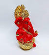 Handcrafted Ganesha idol with a gold base and red terracotta finish, symbolizing prosperity and wisdom, ideal for altars and home decoration.