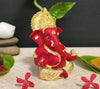 Handcrafted Ganesha idol with a gold base and red terracotta finish, symbolizing prosperity and wisdom, ideal for altars and home decoration.