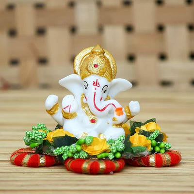 Handmade Ganesha idol crafted from premium resin, weighing 400 grams, measuring 11x11x7 cm, accompanied by a plate, ideal for home altar or car décor, symbolizing wisdom and prosperity."