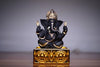 Handcrafted Ganesha idol made of resin, designed for car dashboards, featuring intricate details and vibrant colors.