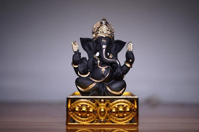 Handcrafted Ganesha idol made of resin, designed for car dashboards, featuring intricate details and vibrant colors.