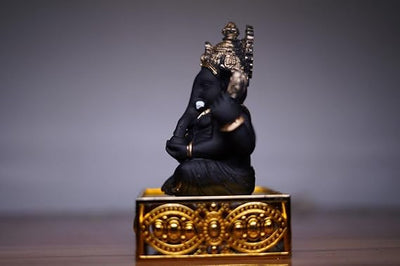 Handcrafted Ganesha idol made of resin, designed for car dashboards, featuring intricate details and vibrant colors.