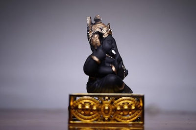 Handcrafted Ganesha idol made of resin, designed for car dashboards, featuring intricate details and vibrant colors.