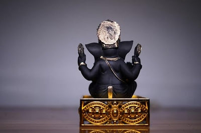 Handcrafted Ganesha idol made of resin, designed for car dashboards, featuring intricate details and vibrant colors.