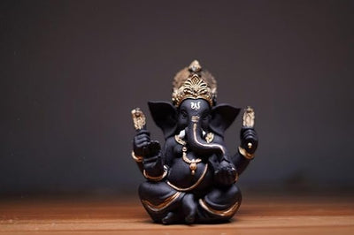 Handcrafted Ganesha idol made of resin, designed for car dashboards, featuring intricate details and vibrant colors.
