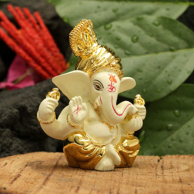 Handcrafted gold-plated Ganesha idol made from ceramic, symbolizing prosperity and positivity, perfect for home decor and altars.