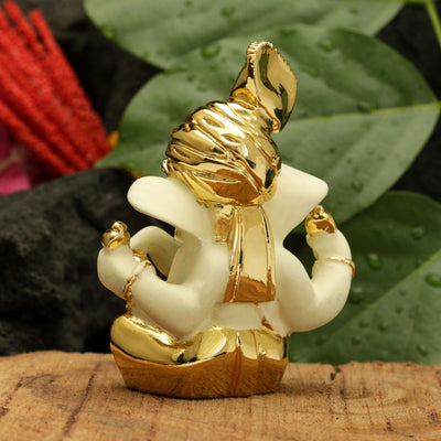 Handcrafted gold-plated Ganesha idol made from ceramic, symbolizing prosperity and positivity, perfect for home decor and altars.