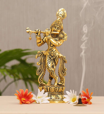 Handcrafted metal Krishna statue playing the flute, featuring intricate details and a gold finish, ideal for home decor or altar.