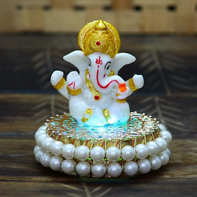 Handcrafted Lord Ganesha idol made of resin, dimensions 8.9 x 8.9 x 8.9 cm, weighing 400 grams, perfect for home and car decor.
