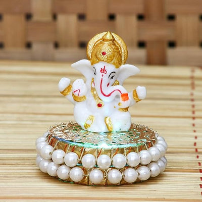 Handcrafted Lord Ganesha idol made of resin, dimensions 8.9 x 8.9 x 8.9 cm, weighing 400 grams, perfect for home and car decor.