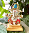 "Handmade ceramic Ganesha idol designed for car dashboard decor, symbolizing wisdom, prosperity, and protection during travels."