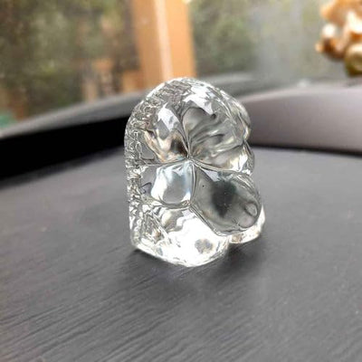 "Handmade Ganesha idol in glass, designed for car dashboards, featuring intricate details and a sleek finish for spiritual protection on the road."
