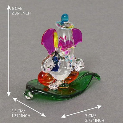 "Handmade Ganesha idol in crystal for car dashboard, featuring intricate details and a radiant finish, perfect for inviting blessings on every journey."