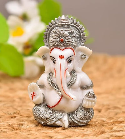 Handmade Ganesha idol in resin for car dashboard, measuring 5.1 cm x 5.1 cm x 7.6 cm, ideal for bringing blessings and positivity while driving