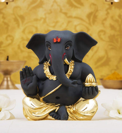 Handmade ceramic Ganesha idol, beautifully crafted as a showpiece, ideal for altars or car dashboards, showcasing intricate details and divine charm