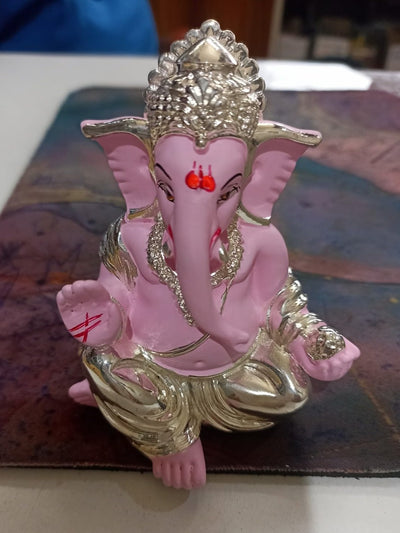 Handmade Ganesha idol in synthetic resin, symbolizing wisdom and prosperity, perfect for altar or car dashboard display.