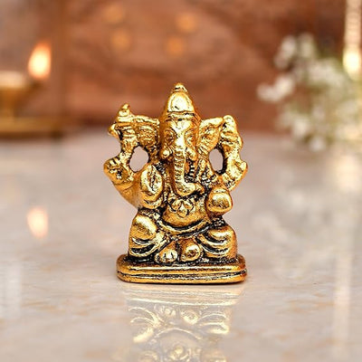 "Handmade Ganesha idol in metal for car dashboard, featuring intricate details and a sleek finish, perfect for inviting blessings on every journey."