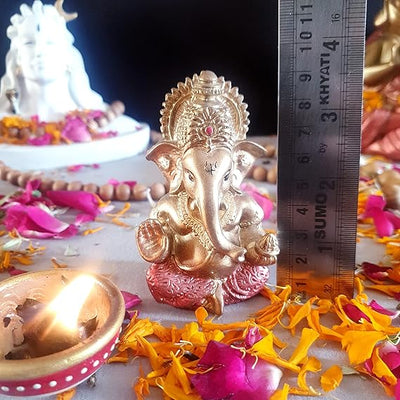 "Handmade Ganesha idol in resin for car dashboard, featuring intricate details and vibrant colors, perfect for inviting blessings on every journey."