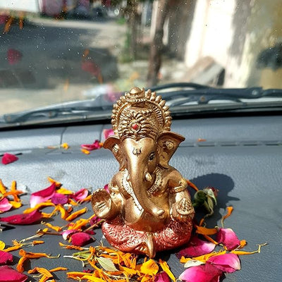 "Handmade Ganesha idol in resin for car dashboard, featuring intricate details and vibrant colors, perfect for inviting blessings on every journey."