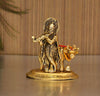 Handcrafted metal statue of Lord Krishna with the Kamadhenu cow, symbolizing abundance and prosperity, featuring intricate design details.