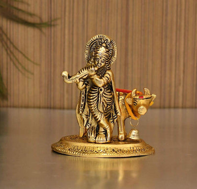 Handcrafted metal statue of Lord Krishna with the Kamadhenu cow, symbolizing abundance and prosperity, featuring intricate design details.