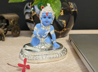 Handmade Krishna idol sitting on a lotus base, crafted from synthetic resin, ideal for pooja, home altar, or as a thoughtful gift.