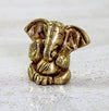 Handmade brass Lord Ganesh idol (0.4 cm x 0.6 cm x 1.2 cm), symbolizing wisdom and prosperity, perfect for pooja rooms and gifts.