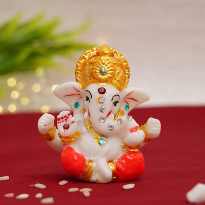 Handmade Lord Ganesh idol (5 cm x 5 cm x 6 cm) for car dashboards, symbolizing wisdom and prosperity, enhancing your driving experience.