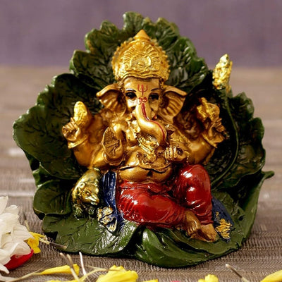 Handmade resin Lord Ganesh idol for pooja rooms, featuring detailed craftsmanship and vibrant colors, symbolizing wisdom and prosperity.