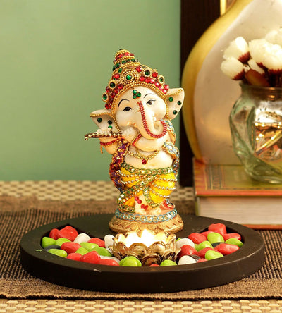 Handmade resin Lord Ganesh idol for pooja rooms, featuring intricate details and vibrant colors, symbolizing wisdom and prosperity.