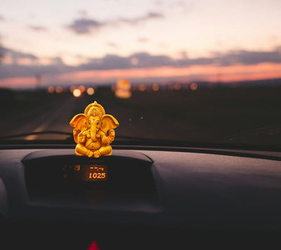Handmade Lord Ganesh idol for car dashboard, crafted from resin, measuring 5L x 5W x 8.9H cm, symbolizing wisdom and good fortune.