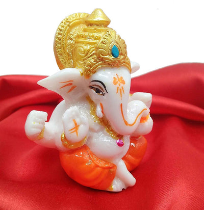 Handmade Lord Ganesh idol for car dashboard and home decor, crafted from resin, measuring 9.4L x 8.4W x 9.6H cm, symbolizing wisdom and prosperity
