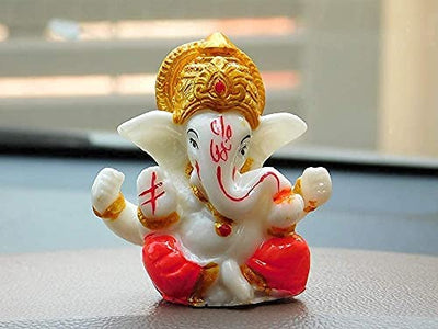 Handmade Lord Ganesh idol for car dashboard and home decor, crafted from resin, measuring 9.4L x 8.4W x 9.6H cm, symbolizing wisdom and prosperity