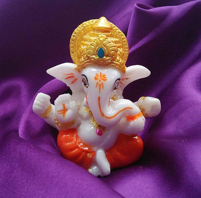 Handmade Lord Ganesh idol for car dashboard and home decor, crafted from resin, measuring 9.4L x 8.4W x 9.6H cm, symbolizing wisdom and prosperity