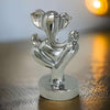 Handmade Lord Ganesh idol crafted from resin, measuring 9L x 9W x 15H cm, symbolizing wisdom and prosperity for home decor