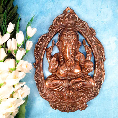 Handmade Lord Ganesh idol wall hanging, crafted from metal, featuring intricate details, measuring 28L x 5W x 40H cm, perfect for home decor