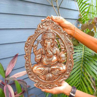 Handmade Lord Ganesh idol wall hanging, crafted from metal, featuring intricate details, measuring 28L x 5W x 40H cm, perfect for home decor.