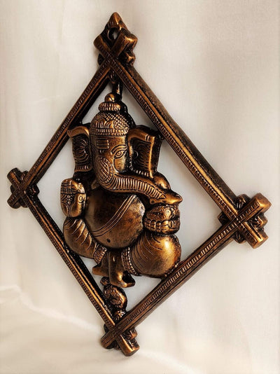 Handmade Lord Ganesh idol wall hanging, crafted from metal, featuring intricate details, measuring 30L x 2W x 32H cm, ideal for altars.