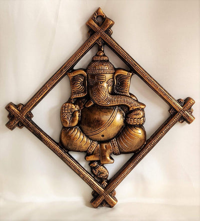 Handmade Lord Ganesh idol wall hanging, crafted from metal, featuring intricate details, measuring 30L x 2W x 32H cm, ideal for altars.