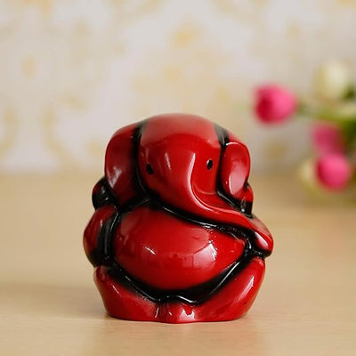 Handmade Lord Ganesha idol made from polyresin, perfect for home, office, or car. Features intricate detailing and a serene expression.